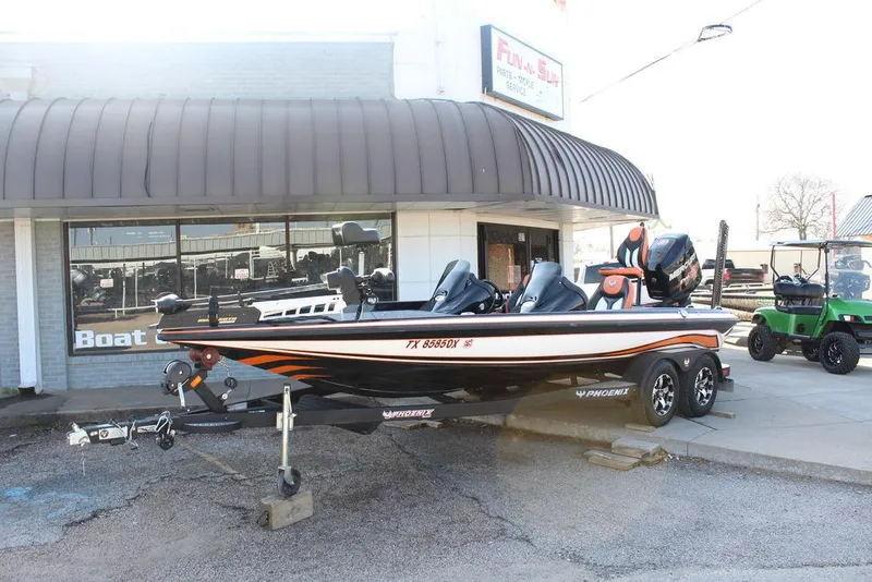 Slide: The Image of 2018 Phoenix 721 ProXP boat parked outside a dealership. - 2