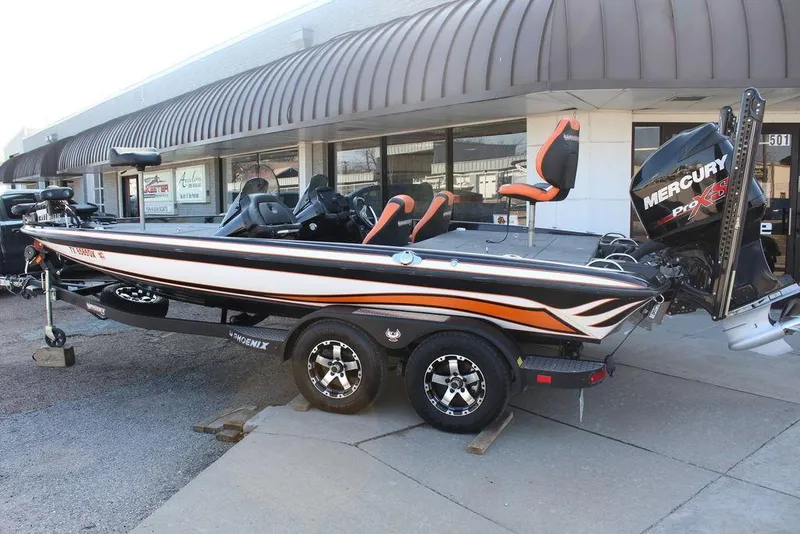 Slide: The Image of 2018 Phoenix 721 ProXP boat with Mercury engine, parked outside a building. - 5