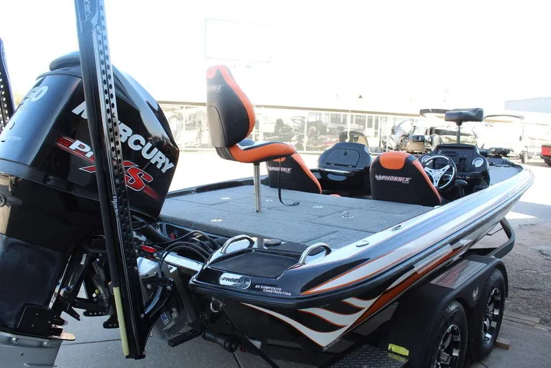 Slide: The Image of 2018 Phoenix 721 ProXP bass boat with Mercury engine, featuring sleek design and dual seating. - 7