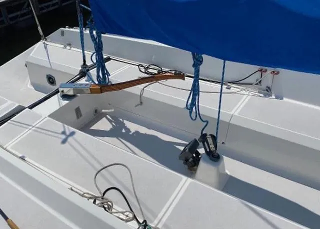 Slide: The Image of 2013 Colgate Sloop sailboat deck with blue cover and rigging. - 5