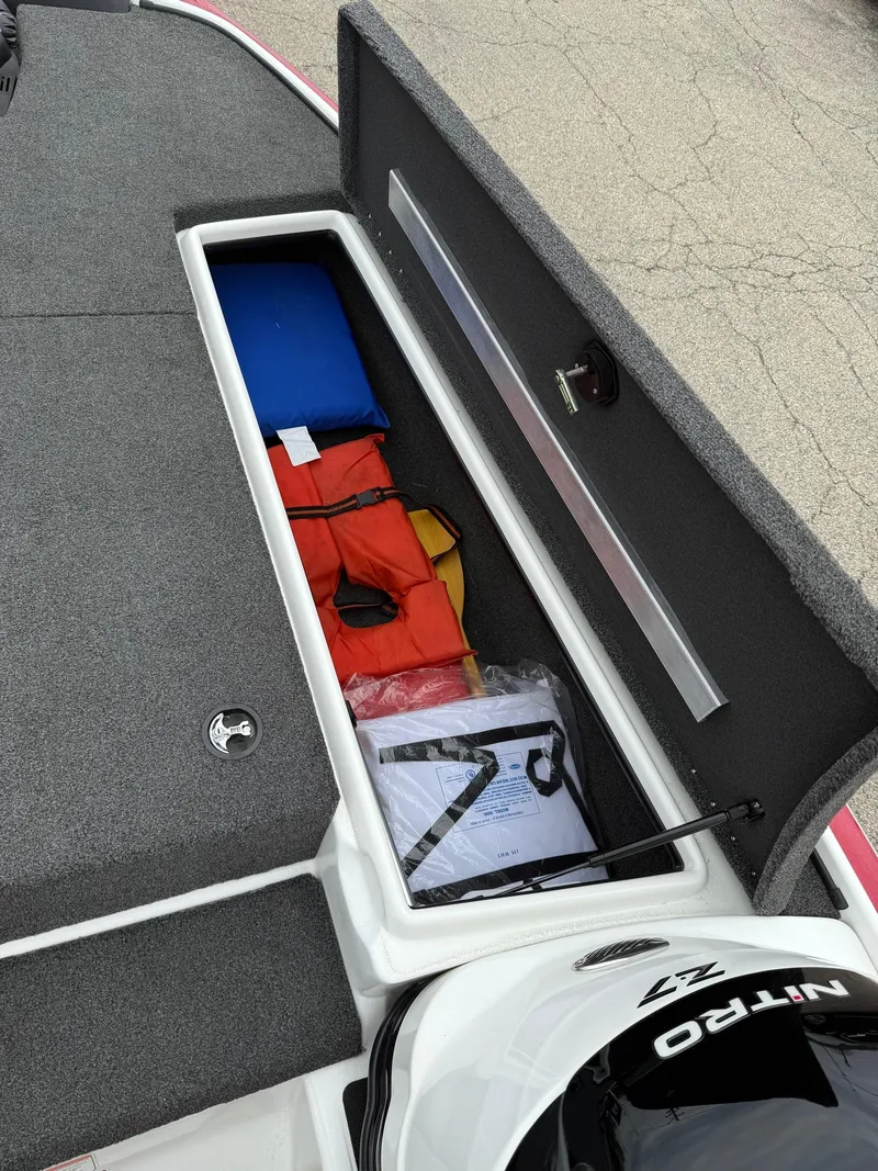 Slide: The Image of Open storage compartment in a 2015 Nitro Z Series Z-7 boat with life jackets. - 12