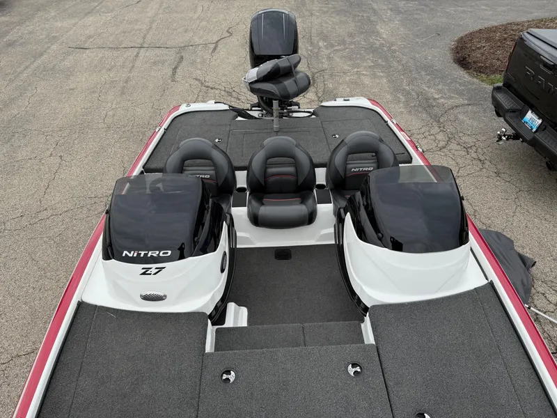 Slide: The Image of 2015 Nitro Z Series Z-7 boat with dual consoles and seating, parked on pavement. - 9