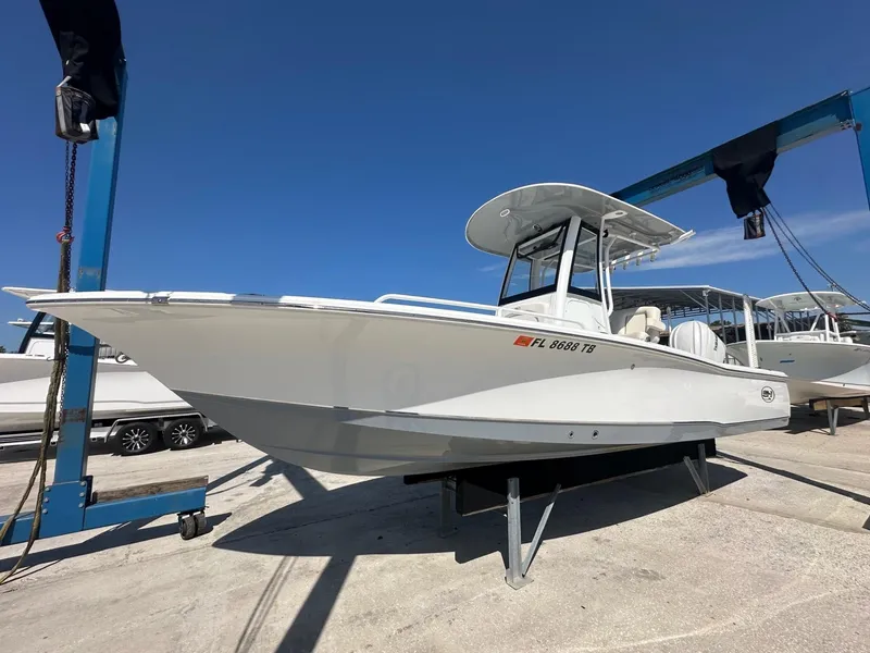 Slide: The Image of 2022 Sea Hunt BX 25 FS boat on display at a marina. - 2