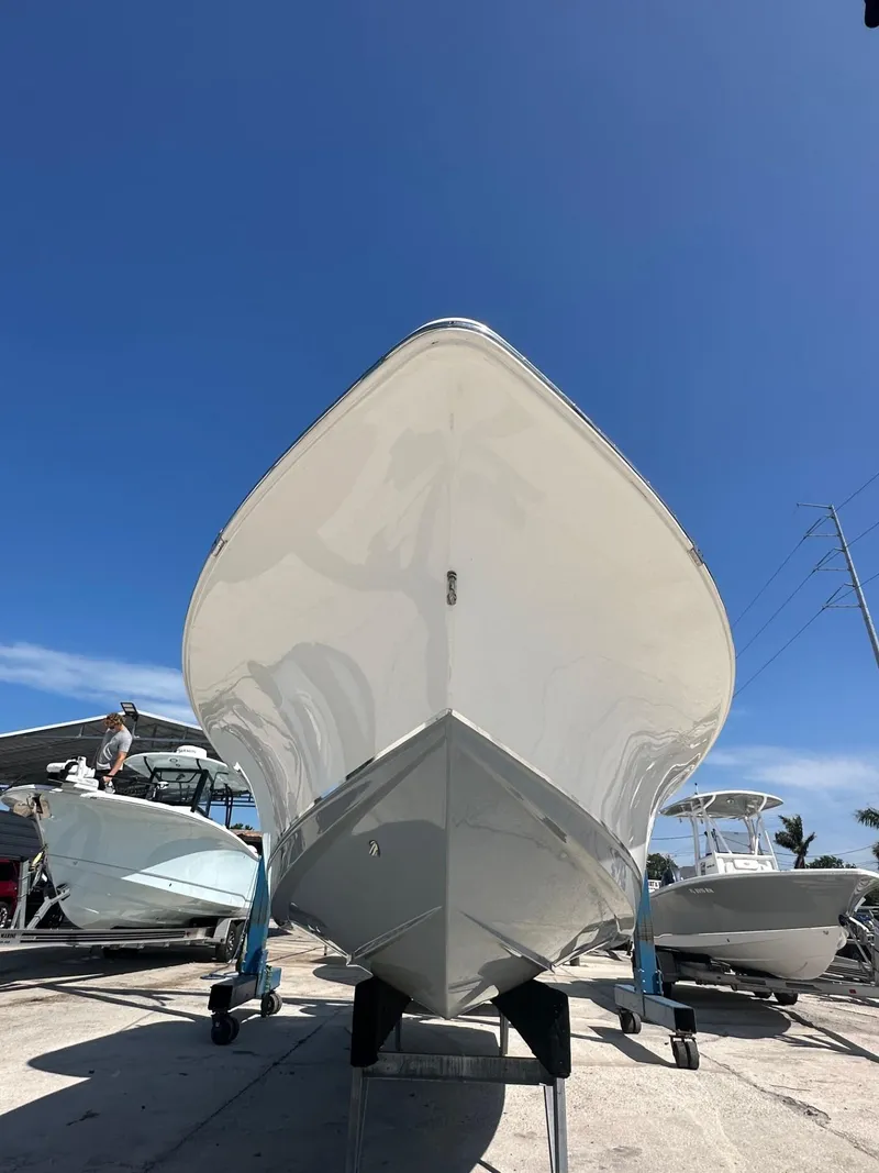 Slide: The Image of 2022 Sea Hunt BX 25 FS boat on display under clear blue sky. - 3