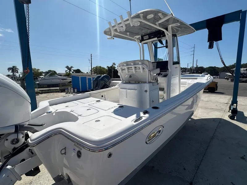 Slide: The Image of 2022 Sea Hunt BX 25 FS boat docked under clear blue sky. - 7