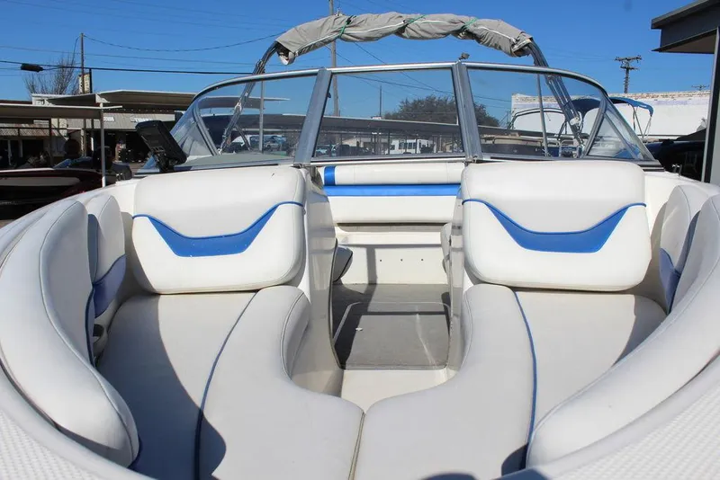 Slide: The Image of 2007 Bayliner 185 BR boat interior with white and blue seating, open bow design. - 10