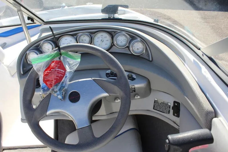 Slide: The Image of 2007 Bayliner 185 BR boat dashboard with steering wheel and instrument gauges. - 13