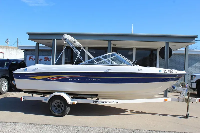 Slide: The Image of 2007 Bayliner 185 BR boat on trailer, parked outside a building. - 3