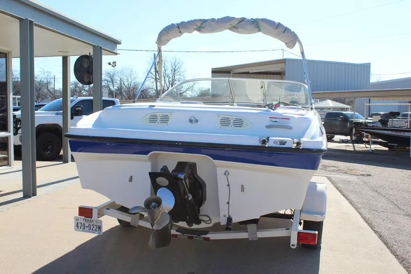 Slide: The Image of 2007 Bayliner 185 BR boat on trailer, rear view with canopy, parked outdoors. - 5