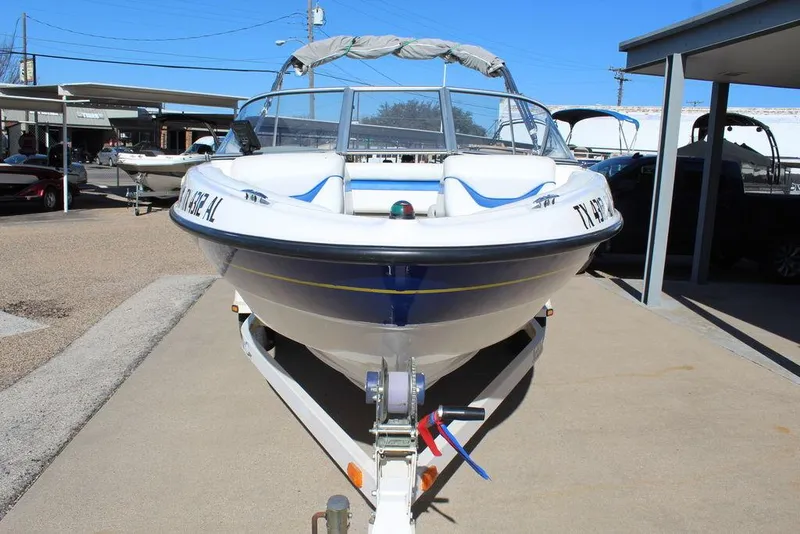 Slide: The Image of 2007 Bayliner 185 BR boat on trailer, parked outdoors under clear blue sky. - 9