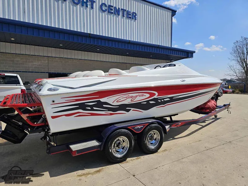 Slide: The Image of 2008 Baja 23 Outlaw speedboat on trailer outside a marine center. - 11