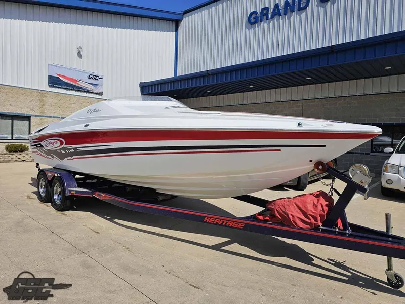 Slide: The Image of 2008 Baja 23 Outlaw speedboat on trailer outside dealership. - 14