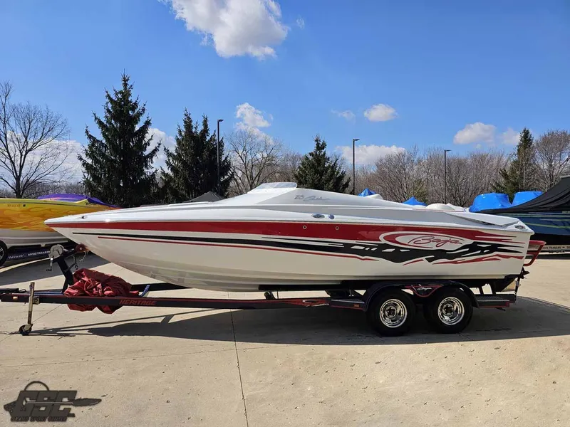 Slide: The Image of 2008 Baja 23 Outlaw speedboat on trailer, red and white design, parked outdoors. - 17
