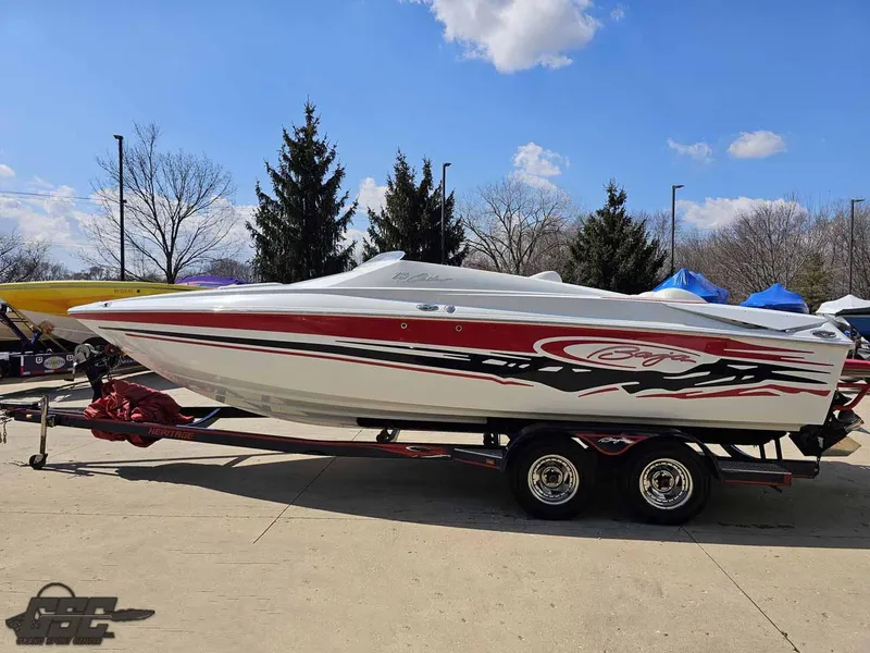 Slide: The Image of 2008 Baja 23 Outlaw speedboat on trailer, featuring sleek design and vibrant graphics. - 18