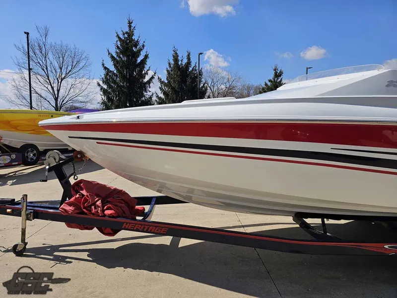 Slide: The Image of 2008 Baja 23 Outlaw boat on trailer, featuring sleek red and white design. - 20