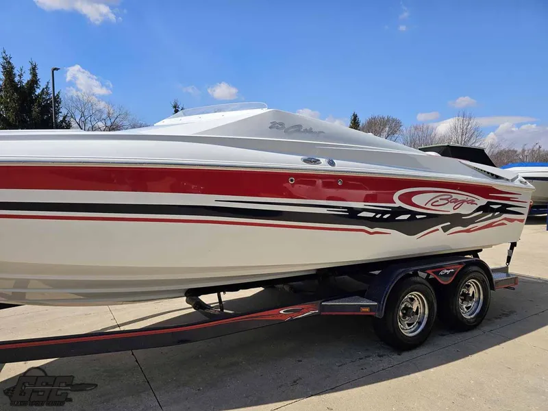 Slide: The Image of 2008 Baja 23 Outlaw speedboat with red and black graphics on a trailer. - 21