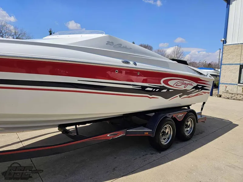 Slide: The Image of 2008 Baja 23 Outlaw speedboat with red and white design on a trailer. - 22