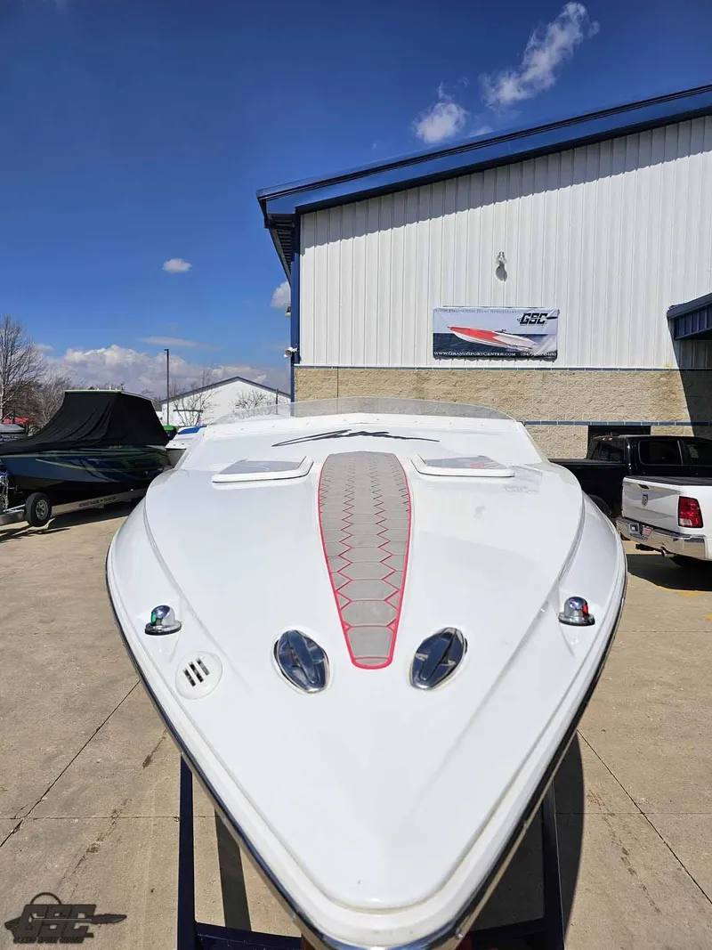 Slide: The Image of 2008 Baja 23 Outlaw boat displayed outdoors, showcasing sleek design and aerodynamic features. - 32