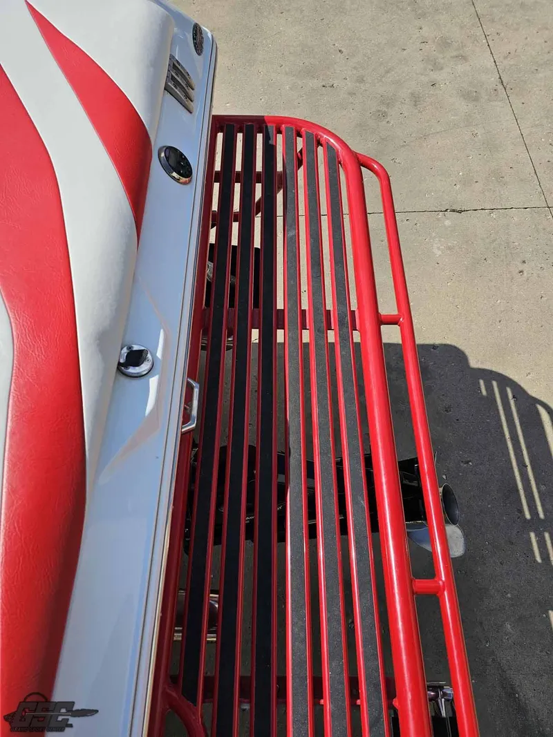 Slide: The Image of 2008 Baja 23 Outlaw boat with red and white detailing, viewed from above. - 44