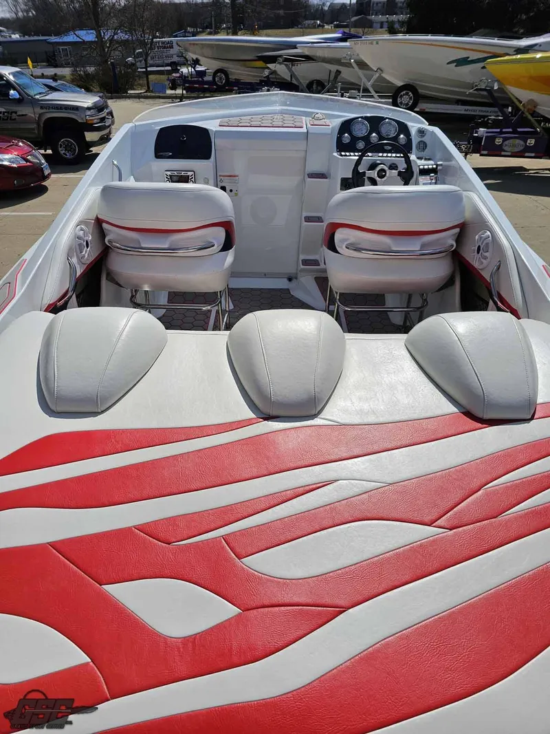 Slide: The Image of 2008 Baja 23 Outlaw boat interior with red and white seating and dashboard. - 47