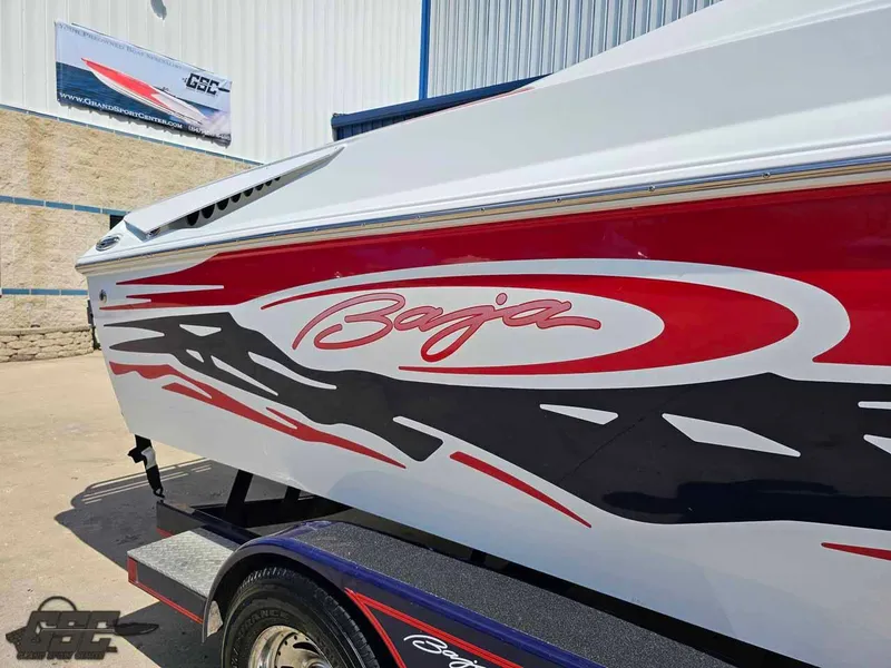 Slide: The Image of 2008 Baja 23 Outlaw boat with red and black graphics on a trailer. - 7
