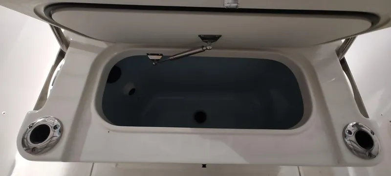 Slide: The Image of Open storage compartment on a 2023 Boston Whaler 220 Dauntless boat. - 22