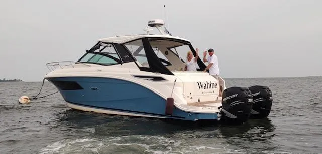 Slide: The Image of 2021 Sea Ray Sundancer 320 OB cruising on open water with two people onboard. - 1