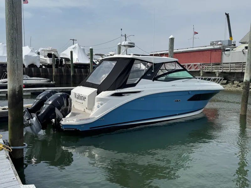 Slide: The Image of 2021 Sea Ray Sundancer 320 OB boat docked in marina, featuring sleek design and twin outboard engines. - 14
