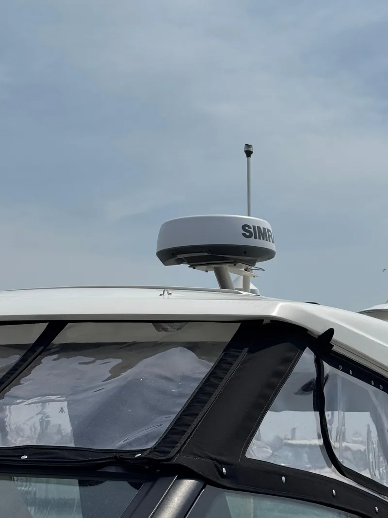 Slide: The Image of 2021 Sea Ray Sundancer 320 OB with Simrad radar, partial view of the cockpit. - 16