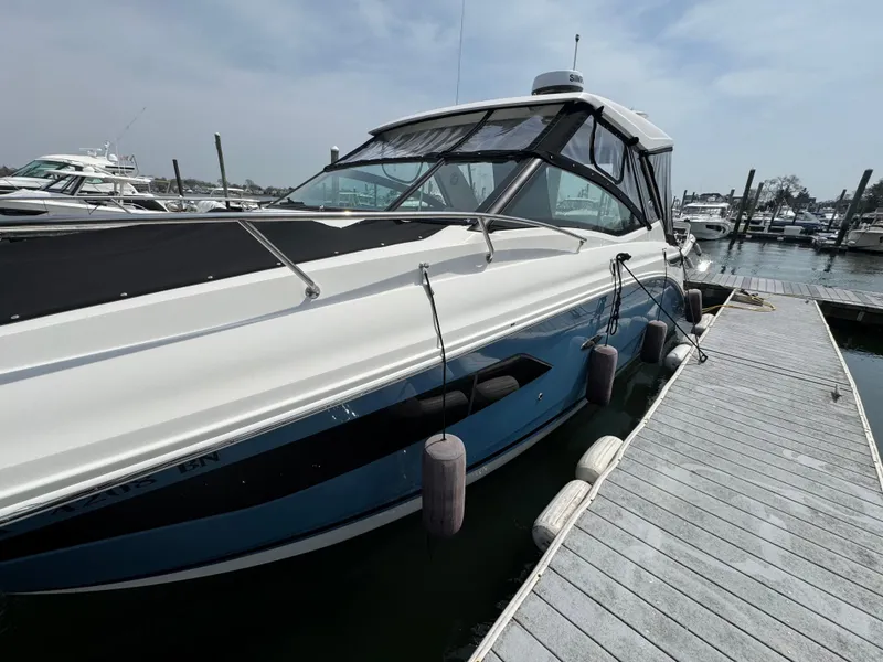 Slide: The Image of 2021 Sea Ray Sundancer 320 OB docked at marina, side view. - 17