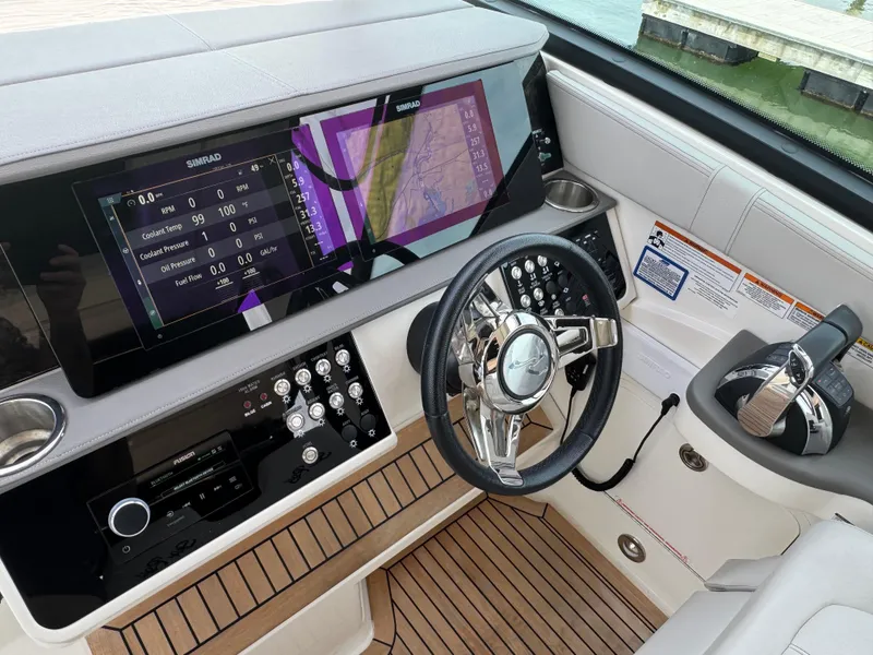 Slide: The Image of 2021 Sea Ray Sundancer 320 OB helm with modern controls and navigation display. - 23