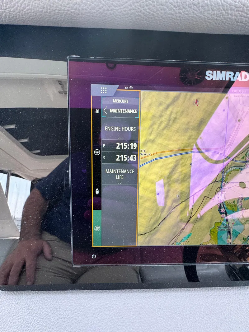 Slide: The Image of Simrad display on 2021 Sea Ray Sundancer 320 OB showing engine hours and maintenance info. - 31