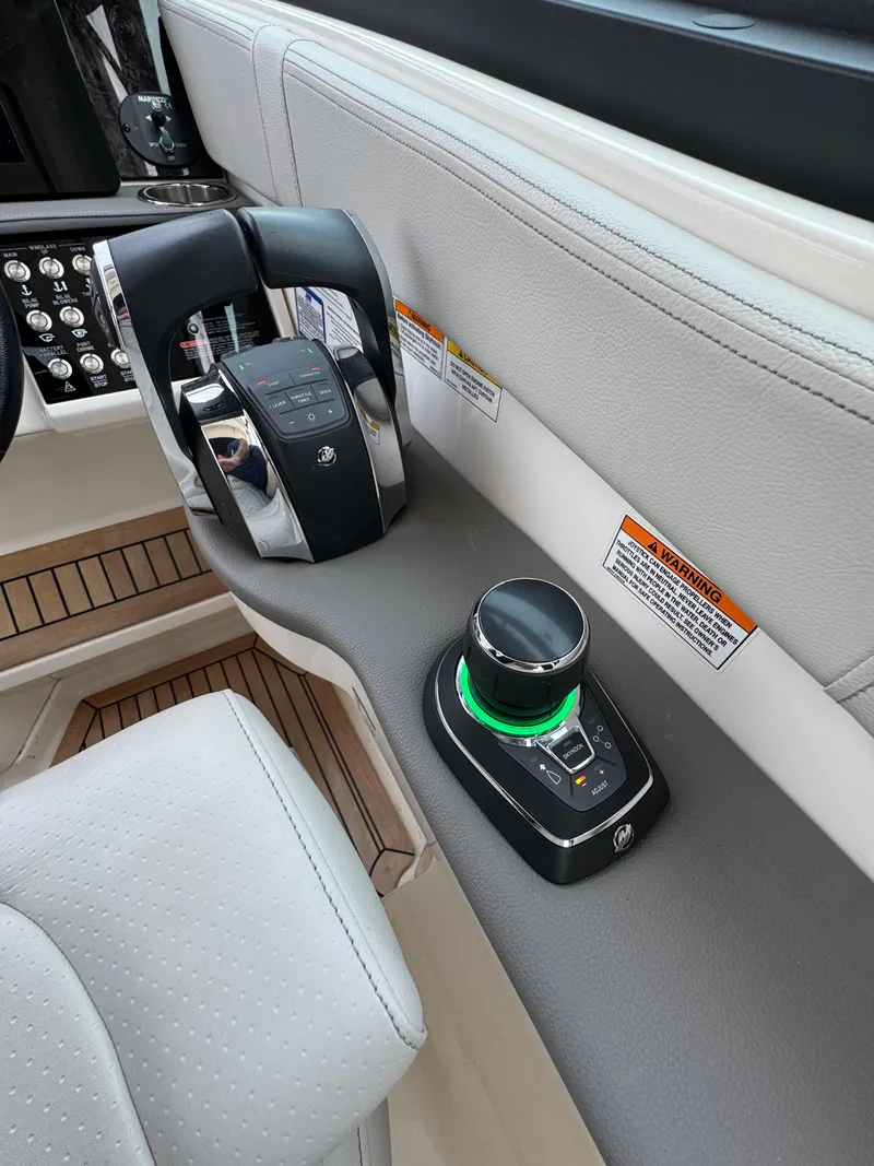 Slide: The Image of 2021 Sea Ray Sundancer 320 OB helm controls with joystick and throttle. - 33
