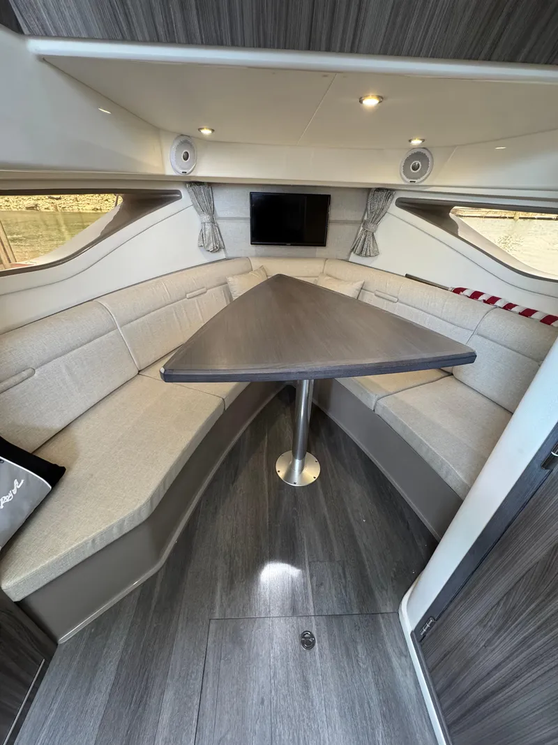 Slide: The Image of Interior of 2021 Sea Ray Sundancer 320 OB with modern seating and triangular table. - 36