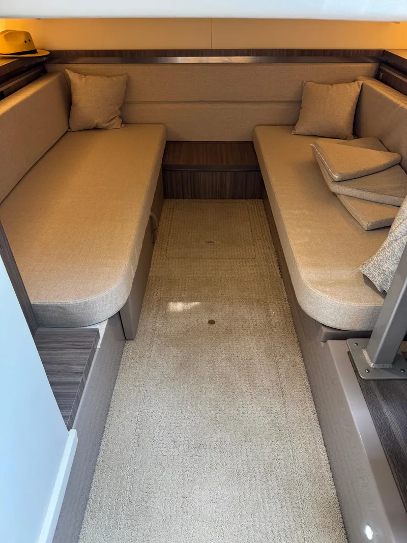 Slide: The Image of 2021 Sea Ray Sundancer 320 OB cabin interior with beige seating and cushions. - 37