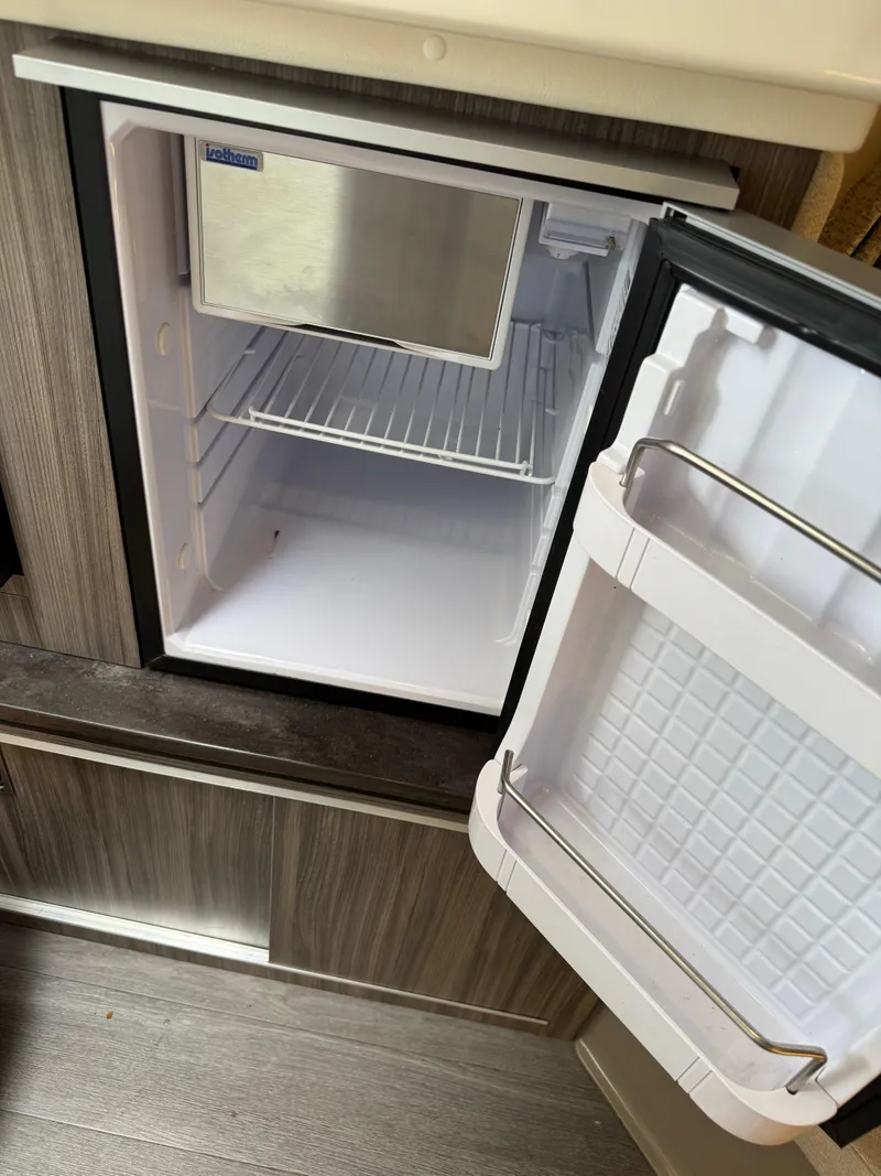 Slide: The Image of Open mini fridge inside 2021 Sea Ray Sundancer 320 OB boat cabin. - 39