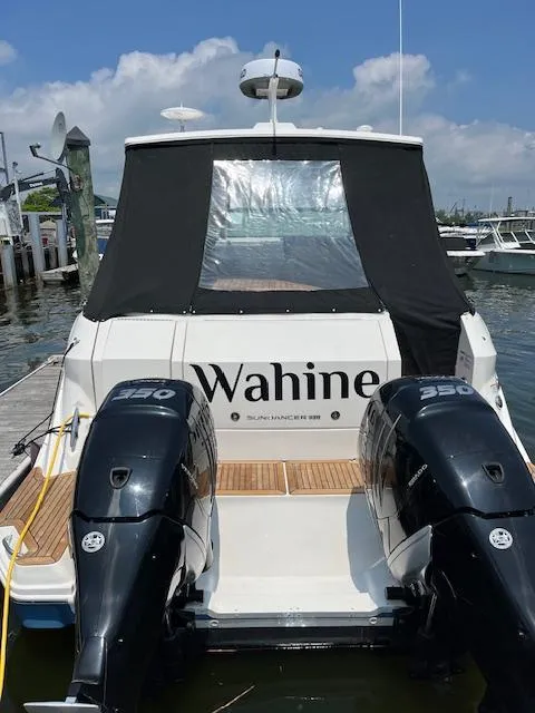 Slide: The Image of 2021 Sea Ray Sundancer 320 OB boat docked, featuring dual outboard engines. - 4