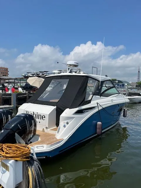Slide: The Image of 2021 Sea Ray Sundancer 320 OB docked, featuring sleek design and outboard engines. - 6