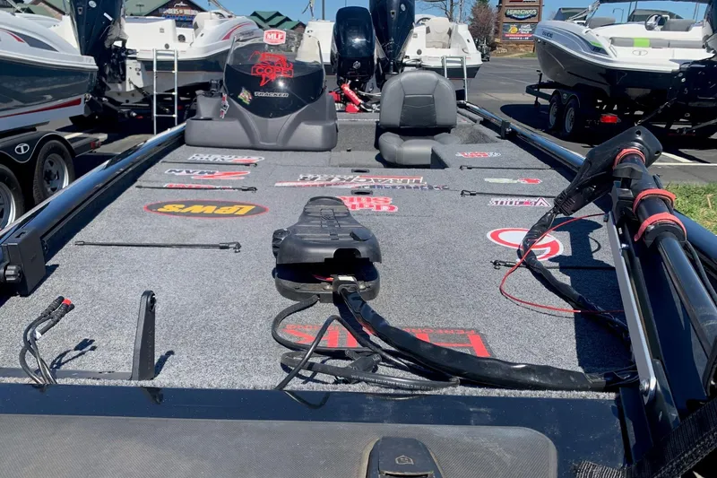 Slide: The Image of 2024 Tracker PRO170 boat interior with fishing gear and brand logos. - 4