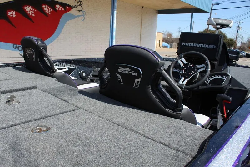 Slide: The Image of 2025 Skeeter FXR21L boat interior with Humminbird electronics and comfortable seating. - 13