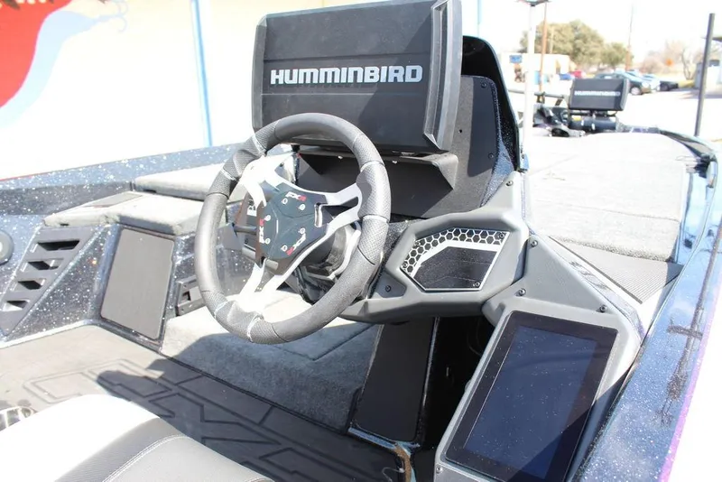 Slide: The Image of 2025 Skeeter FXR21L boat cockpit with Humminbird electronics and modern steering wheel. - 14
