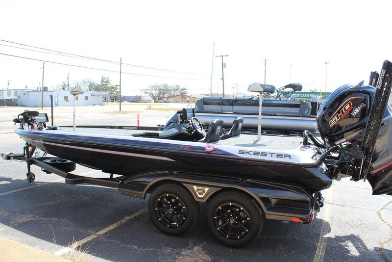 Slide: The Image of 2025 Skeeter FXR21L bass boat on trailer, side view. - 7