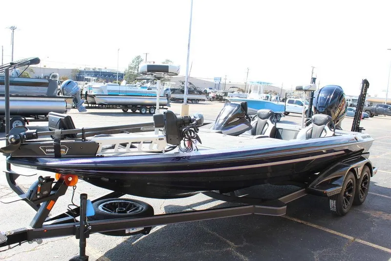 Slide: The Image of 2025 Skeeter FXR21L bass boat on trailer in parking lot. - 8