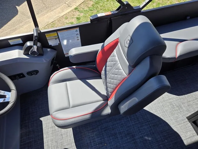 Slide: The Image of Captain's chair in 2025 Godfrey Sweetwater 2286 SFLC boat, featuring gray and red upholstery. - 16