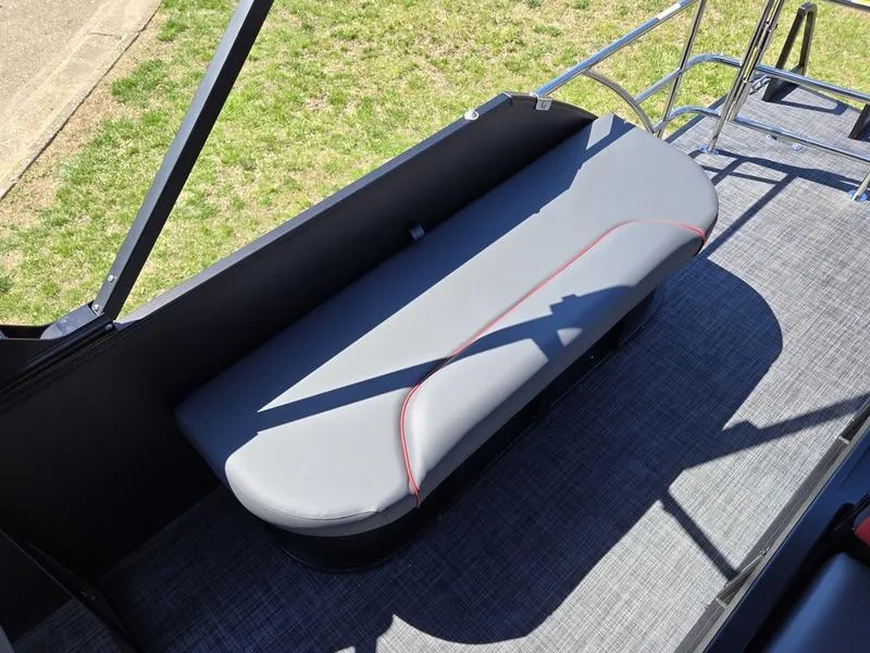 Slide: The Image of 2025 Godfrey Sweetwater 2286 SFLC boat seat with sleek gray upholstery and red accents. - 2