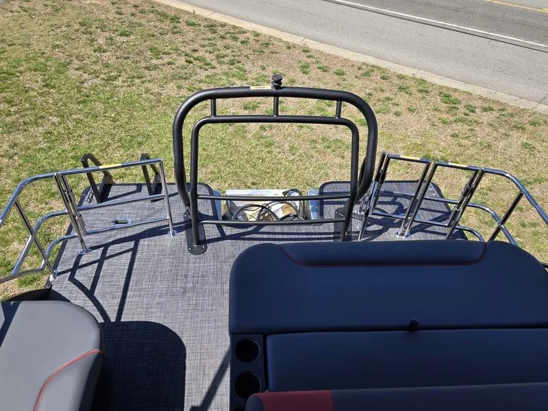 Slide: The Image of 2025 Godfrey Sweetwater 2286 SFLC boat deck with seating and railing, parked on grass. - 5