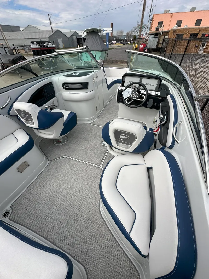 Slide: The Image of 2025 Crownline E235 boat interior with modern seating and steering console. - 6