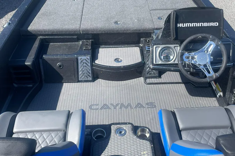 Slide: The Image of 2025 Caymas CX 20 PRO boat interior with steering wheel and Humminbird electronics. - 2