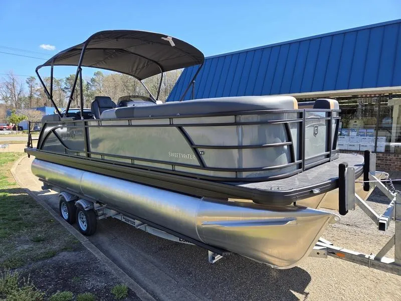Slide: The Image of 2025 Godfrey Sweetwater 2286 SB pontoon boat on trailer, parked outdoors. - 4