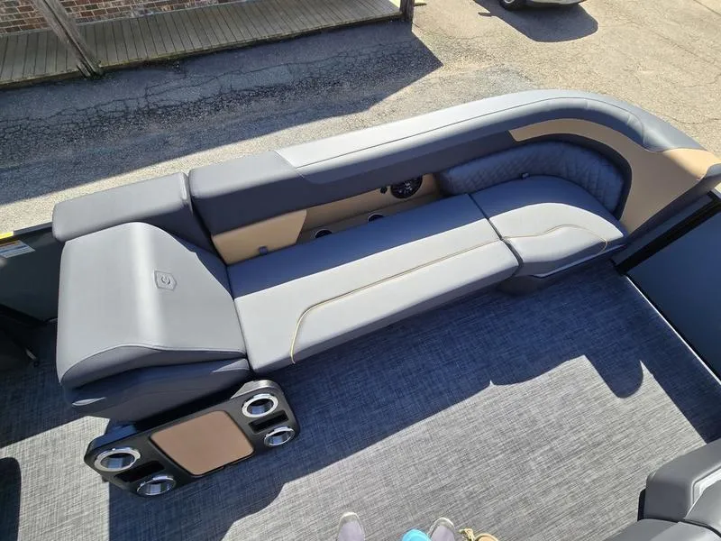 Slide: The Image of 2025 Godfrey Sweetwater 2286 SB boat interior with gray seating and cup holders. - 8